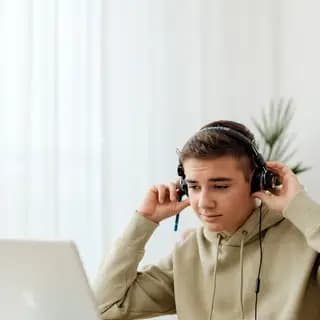 Student using headphones for an IELTS online lesson